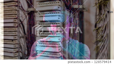 Image of men using vr headset over server room 128579414