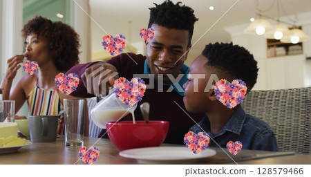 Image of heart icons with flowers over african american family eating breakfast Image of heart icons with flowers over african american family eating breakfast 128579466