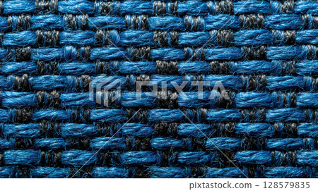 Close-up of blue and black woven fabric texture with interlaced pattern for soft background 128579835