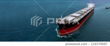 Aerial view bulk carrier cargo ship vessel global business logistic import export industry, Bulk carrier cargo ship vessel dry general cargo vessel underway on sea to port. Aerial view bulk carrier cargo ship vessel global business logistic import export industry, Bulk carrier cargo ship vessel dry general cargo vessel underway on sea to port. 128579897