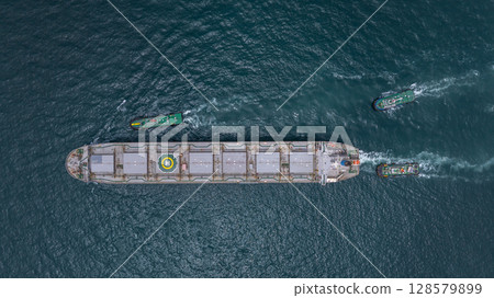 Aerial view bulk carrier cargo ship vessel global business logistic import export industry, Bulk carrier cargo ship vessel dry general cargo vessel underway on sea to port. Aerial view bulk carrier cargo ship vessel global business logistic import export industry, Bulk carrier cargo ship vessel dry general cargo vessel underway on sea to port. 128579899