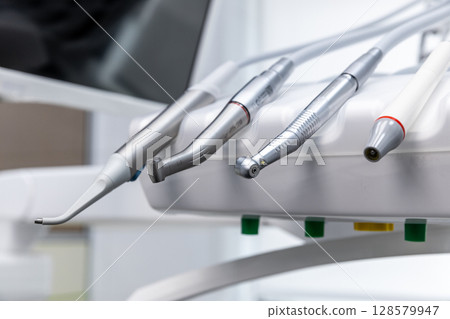 Modern Dental Instruments Displayed in a Clean Clinic Environment Featuring Various Tools for Dental Care and Treatment Procedures in a Professional Healthcare Setting 128579947