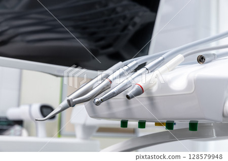 Advanced Dental Equipment and Instruments Present in a Modern Dental Clinic Setting Displaying Cutting-Edge Technology for Patient Care and Treatment Procedures in Healthcare Advanced Dental Equipment and Instruments Present in a Modern Dental Clinic Setting Displaying Cutting-Edge Technology for Patient Care and Treatment Procedures in Healthcare 128579948