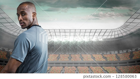 Male athlete is standing and looking back in flat design stadium with floodlights and seating tiers Male athlete is standing and looking back in flat design stadium with floodlights and seating tiers 128580063