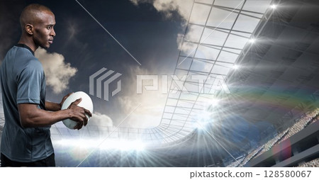 Male athlete is standing in flat design sports stadium under floodlights, holding white ball Male athlete is standing in flat design sports stadium under floodlights, holding white ball 128580067