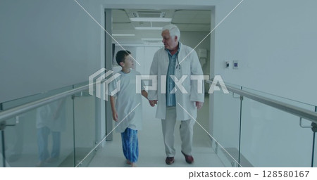 Doctor is wearing stethoscope and walking with patient in flat corridor with glass rails, health 128580167