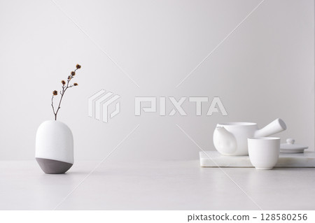 Elegant Korean table setting with traditional Korean bojagi gift wrapping for Chuseok, ceramic vase and fabric, tree branches. 128580256