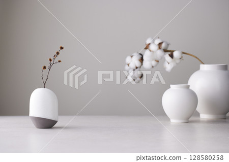 Elegant Korean table setting with traditional Korean bojagi gift wrapping for Chuseok, ceramic vase and fabric, tree branches. 128580258