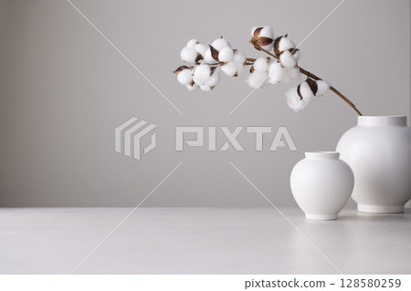 Elegant Korean table setting with traditional Korean bojagi gift wrapping for Chuseok, ceramic vase and fabric, tree branches. 128580259