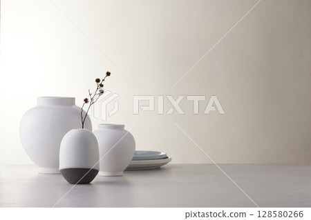 Elegant Korean table setting with traditional Korean bojagi gift wrapping for Chuseok, ceramic vase and fabric, tree branches. 128580266