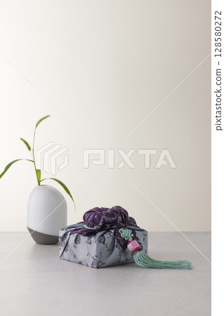 Elegant Korean table setting with traditional Korean bojagi gift wrapping for Chuseok, ceramic vase and fabric, tree branches. 128580272