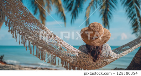 A peaceful scene of relaxation on a tropical beach, featuring a woman enjoying a hammock swing with palm trees, ocean in the background. Perfect for themes of vacation, leisure, and summer tranquility A peaceful scene of relaxation on a tropical beach, featuring a woman enjoying a hammock swing with palm trees, ocean in the background. Perfect for themes of vacation, leisure, and summer tranquility 128580354