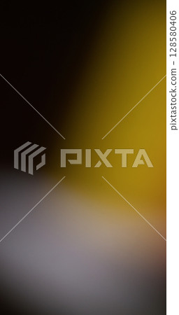 Light blur leak. Film burn. Yellow white color defocused spot glowing on black background. Night abstract cinematic texture optical effect. 128580406