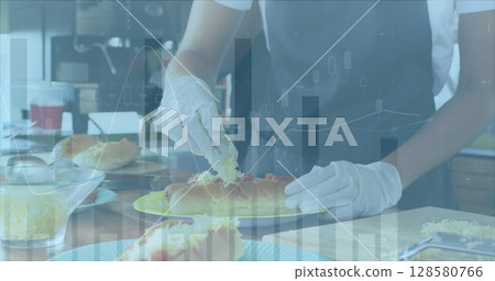 Image of financial data processing over biracial chef in kitchen 128580766