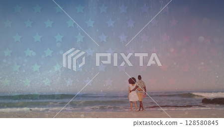 Image of stars over back of african american couple walking on beach 128580845
