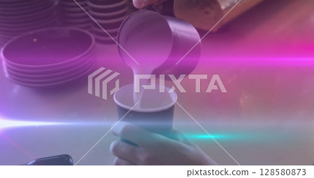 Image of light spots over caucasian man pouring milk in coffee 128580873