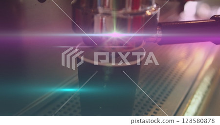 Image of light spots over biracial man preparing coffee in cafe 128580878