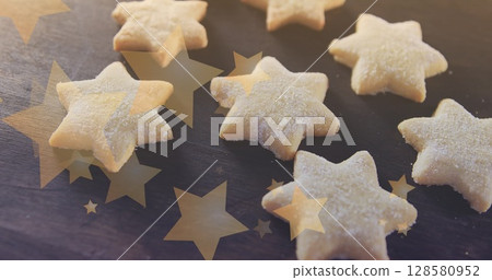 Image of stars floating over homemade cookies 128580952