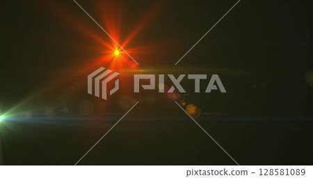 Image of glowing spots of lights over dark background 128581089