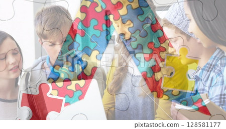 Image of puzzle pieces over diverse schoolchildren using laptop 128581177