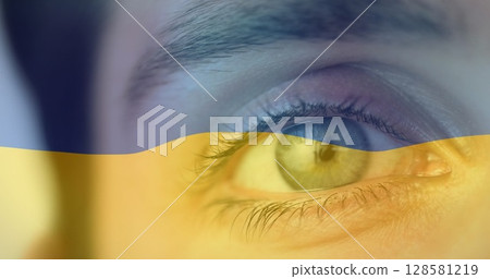 Image of flag of ukraine waving over open eye of caucasisan woman Image of flag of ukraine waving over open eye of caucasisan woman 128581219