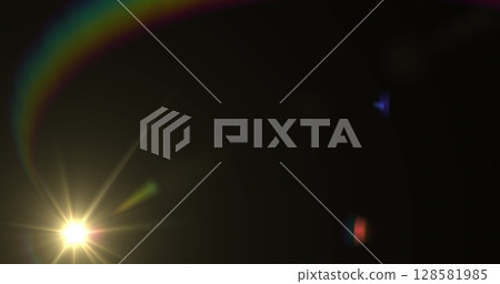 Image of glowing spot light with prism moving on black background 128581985