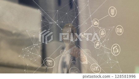Image of network of connections with icons over caucasian businessman 128581996
