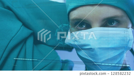 Observing surgeon monitoring vital signs through HUD overlay in operating room, with mask and cap 128582232
