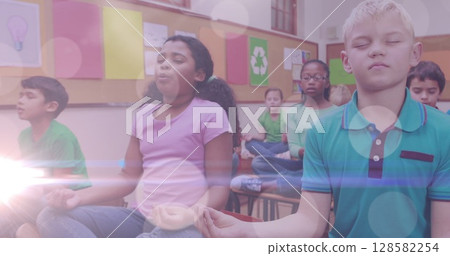 Image of lights over diverse pupils practicing yoga at school 128582254