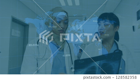 Image of world map and financial data over diverse female doctors with x ray photo 128582358