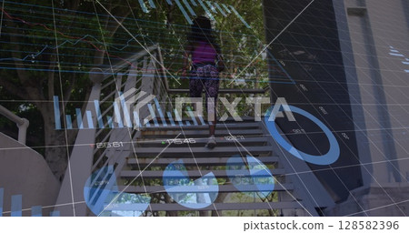 Image of financial graphs and data over african american woman running upstairs 128582396