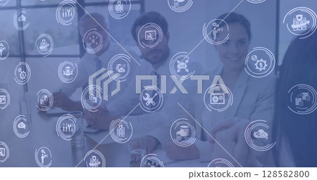 Multiple digital icons against group of diverse office colleagues in meeting room at office Multiple digital icons against group of diverse office colleagues in meeting room at office 128582800