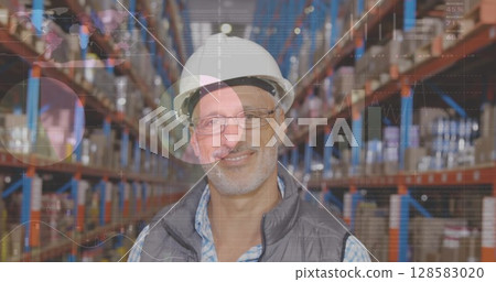 Image of statistics and data processing over smiling caucasian man working in warehouse 128583020