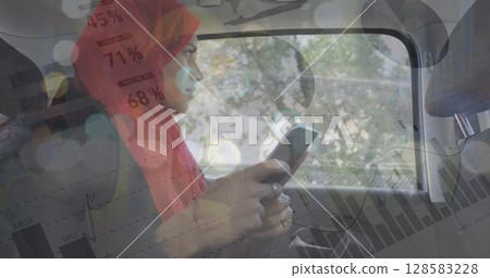 Statistical data processing against woman in hijab using smartphone in the car Statistical data processing against woman in hijab using smartphone in the car 128583228