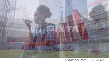 Image of financial data and virus cells over african american doctor using smartphone 128583259