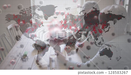 Managing senior couple using laptop, sorting pills on table by window with world map, copy space 128583267