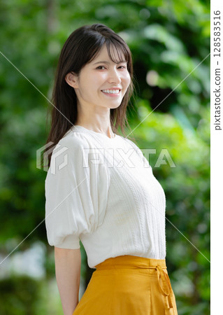 A woman turning around with a smile A woman turning around with a smile 128583516