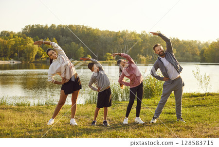 Happy Family Embraces Fitness Together in Nature Happy Family Embraces Fitness Together in Nature 128583715