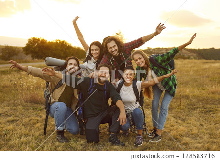 Group of happy young friends having fun while hiking or trekking together in autumn Group of happy young friends having fun while hiking or trekking together in autumn 128583716