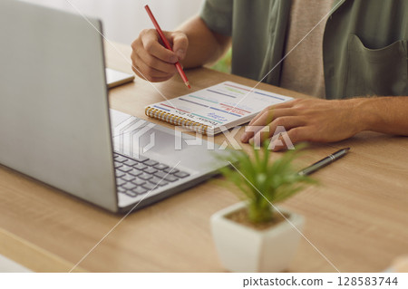 Businessman writing tasks and to do list in plan schedule calendar sitting in office. 128583744