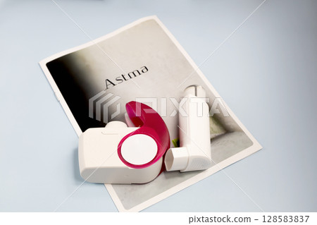 Asthma inhalers and a brochure with the inscription asthma 128583837