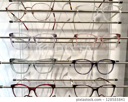 Large selection glasses frames on a shelf in a store Large selection glasses frames on a shelf in a store 128583841
