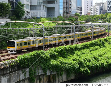 E231 series 500 Chuo-Sobu local train running alongside the Kanda River 128583933
