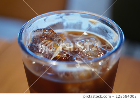 Close-Up of Iced Coffee with Ice Cubes in Glass Close-Up of Iced Coffee with Ice Cubes in Glass 128584002