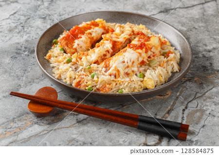 Baked Pork Cutlet on Rice in Hong Kong style with tomato gravy topped with melted cheese closeup in a plate. horizontal 128584875