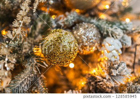Merry Christmas Xmas happy holidays. Golden silver ornament decoration ball, defocused garland lights on classic decorated Christmas tree. Christmas tree with frosty ornaments. Christmas eve at home Merry Christmas Xmas happy holidays. Golden silver ornament decoration ball, defocused garland lights on classic decorated Christmas tree. Christmas tree with frosty ornaments. Christmas eve at home 128585945