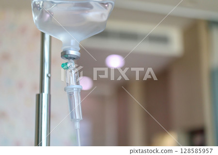Close up medical intravenous IV drip in hospital background Close up medical intravenous IV drip in hospital background 128585957