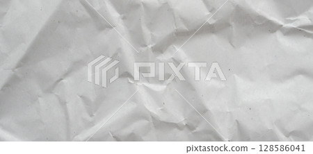 Abstract white crumpled and creased recycle paper texture background 128586041