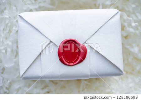 Wax seal stamp on white paper wrap packaging parcel box 128586699