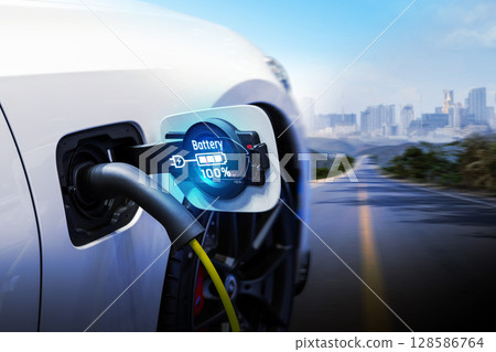 Power cable pump plug in charging power to electric vehicle EV car. 128586764